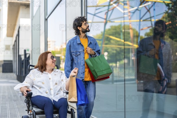 Smiling couple with shopping bags walking by a storefront window, enjoying a day of shopping together