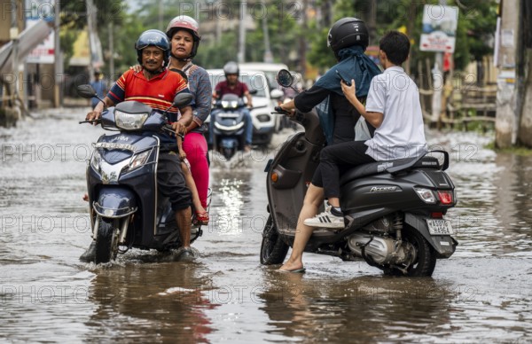 Commuters passing through a waterlogged street following heavy rainfall in Guwahati, India, on 1 June 2025, Asia