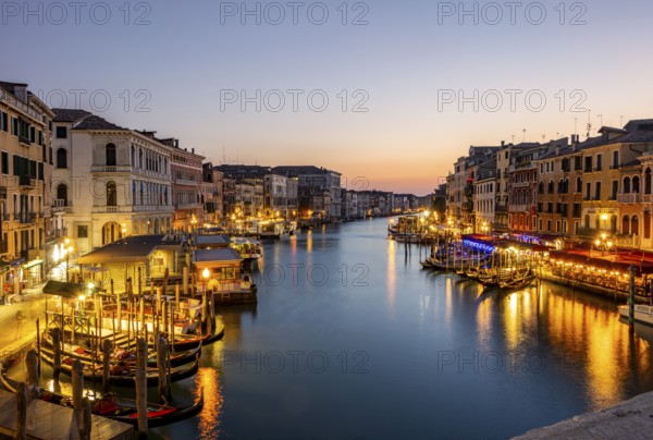 View of the Grand Canal at the blue hour, picturesque evening mood with illuminated palazzos on the canal, long exposure, view from the Rialto Bridge, Venice, Veneto, Italy, Europe