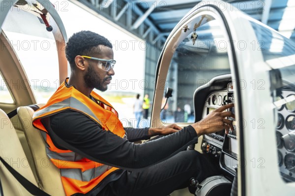 Aircraft engineer meticulously checks the instruments and controls inside the cockpit of a small plane, ensuring its safety and optimal performance before flight