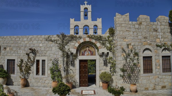 Church façade with bell tower and religious icon, surrounded by plants, woman's monastery, Evangelismou Monastery, Patmos, Dodecanese, Greek Islands, Greece, Europe