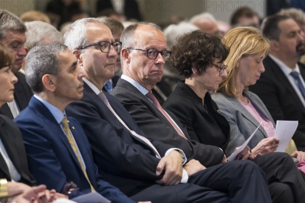 Ugur Sahin (founder of Biontech SE), Andreas Voßkuhle (President of the Senate of the German National Foundation), Friedrich Merz (Chancellor of the Federal Republic of Germany) and Özlem Türeci (founder of Biontech SE) at the award ceremony for the German National Prize 2025 in the Französische Friedrichstadtkirche, Berlin, on 10 June 2025