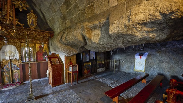 Church interior with icons and wooden benches set into a stone wall, Cave of St John, Grotto of Spileo Apokalipsis, Monastery of the Revelation, Moni tis Apokalipsis, World Heritage Site 1999, Patmos, Dodecanese, Greek Islands, Greece, Europe