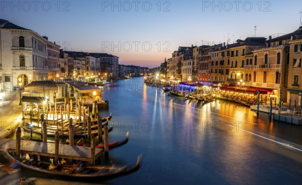 View of the Grand Canal at the blue hour, picturesque evening mood with illuminated palazzos on the canal, long exposure, view from the Rialto Bridge, Venice, Veneto, Italy, Europe