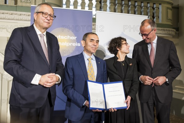 Thomas Mirow (Chairman of the Board of the German National Foundation), Ugur Sahin and Özlem Türeci (founders of Biontech SE) and Friedrich Merz (Chancellor of the Federal Republic of Germany) at the award ceremony for the German National Prize 2025 in the Französische Friedrichstadtkirche, Berlin, on 10 June 2025