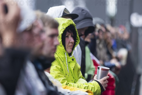 A festival visitor wearing a rain jacket stands in the front row at the Rock am Ring Festival on Sunday, Nürburgring race track race track, 08/06/2025