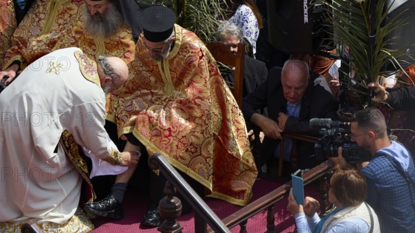 A priest in a golden robe blesses another, surrounded by cameras and a crowd, Orthodox ceremony, monks of St John's Monastery, ceremonial washing of feet, procession, Maundy Thursday, Megali Pempti, Chora, Patmos, Dodecanese, Greek Islands, Greece, Europe