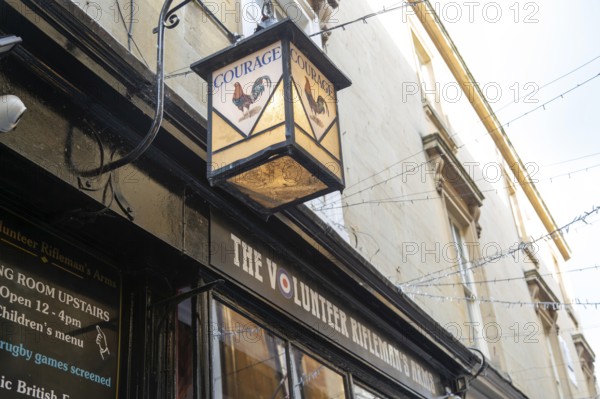 Vintage Courage pub lamp sign outside The Volunteer Rifleman's Arms pub, city of Bath, north east Somerset, England, UK