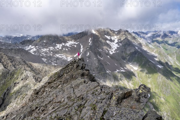 Hiker on a rock, Lasörling Höhenweg, Lasörling Group, Hohe Tauern National Park, East Tyrol, Tyrol, Austria, Europe
