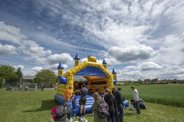 Children's fun, bouncy castle and football games in a meadow during the baking oven festival, Kleingeschaidt, Middle Franconia, Bavaria, Germany, Europe
