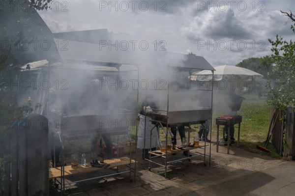 Heavy smoke at the sausage grill stations at the Backofenfest, Kleingeschaidt, Middle Franconia, Bavaria, Germany, Europe