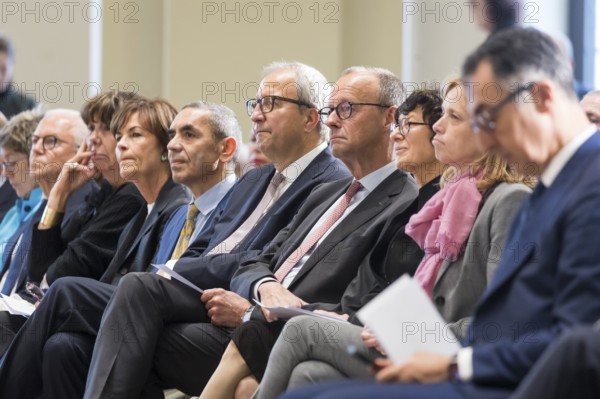 Ugur Sahin (founder of Biontech SE), Andreas Voßkuhle (President of the Senate of the German National Foundation), Friedrich Merz (Chancellor of the Federal Republic of Germany) and Özlem Türeci (founder of Biontech SE) at the award ceremony for the German National Prize 2025 in the Französische Friedrichstadtkirche, Berlin, on 10 June 2025