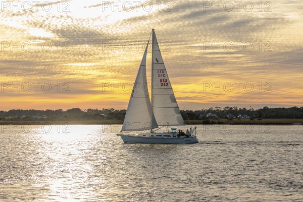 Sailboat sailing on the Tolomato River near Vilano Beach, Florida at sunset