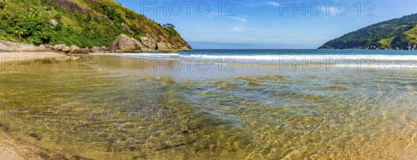 Clear waters at Bonete beach in Ilhabela surrounded by hills and forest, Ilhabela, Sao Paulo, Brazil, South America