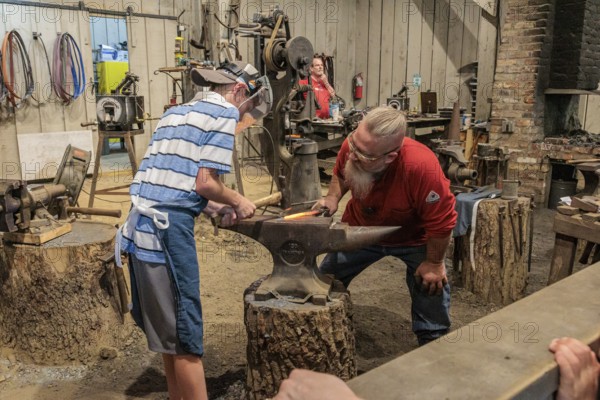 Park guest gets hands on experience at the Valley Forge Blacksmith demonstration at the Dollywood amusement park in Pigeon Forge, TN