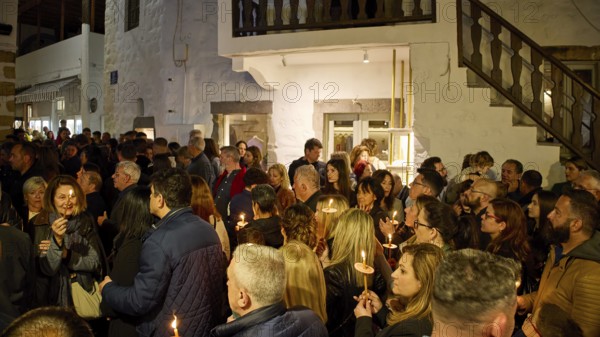 Good Friday, Church of Agios Ioannis Prodromos, Churchgoers, Large crowd with candles at a night-time celebration in front of a building, Skala, harbour, Patmos, Dodecanese, Greek Islands, Greece, Europe