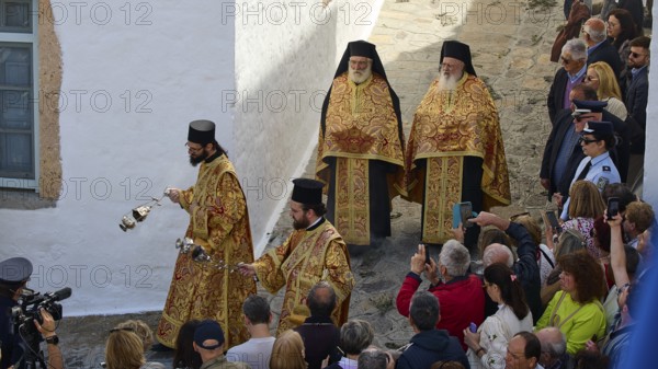 Priests in costly vestments lead a procession through a crowd as people watch and take photos, Orthodox ceremony, monks of St John's Monastery, ceremonial foot washing, procession, Maundy Thursday, Megali Pempti, Chora, Patmos, Dodecanese, Greek Islands, Greece, Europe