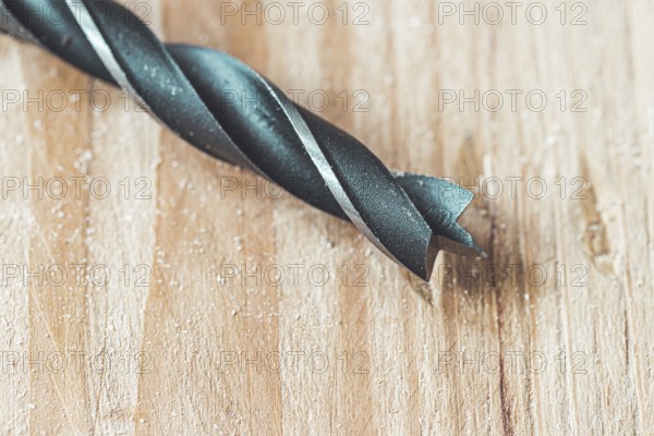 Close up of driller lying on wooden plank