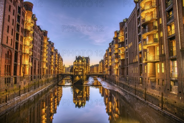 The old warehouse district with the moated castle in Hamburg, Germany, at dusk, Europe