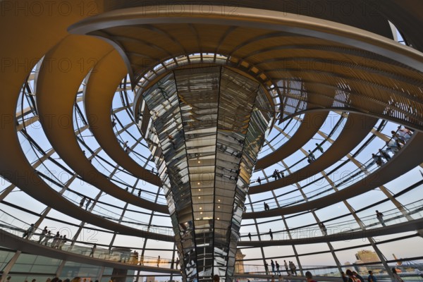 Reichstag building in Berlin. The large glass dome at the very top of the Reichstag has a 360-degree view of the surrounding Berlin cityscape. The main hall of the parliament below can also be seen from inside the dome, and natural light from above radiates down to the parliament floor. The Reichstag building is a historical edifice in Berlin, Germany, Europe