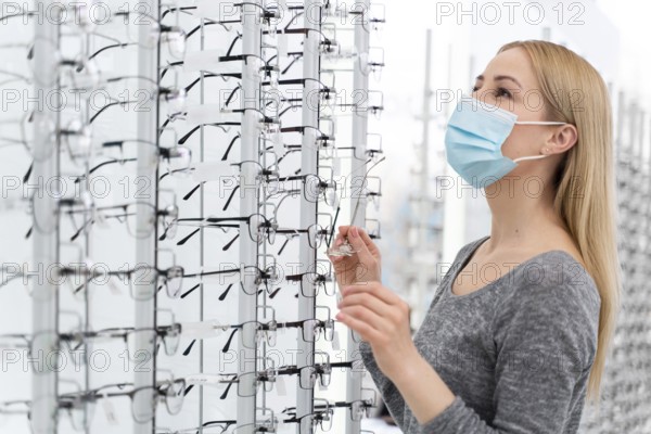 Woman with mask store trying glasses 4
