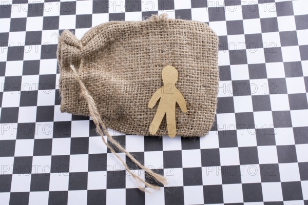 Man shape cut out of paper on canvas sack