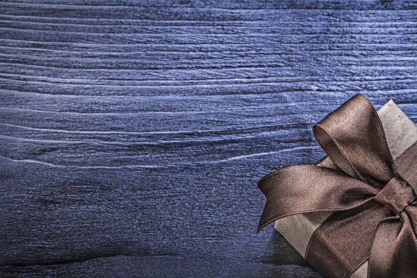 Gift box with present on wooden board copy space