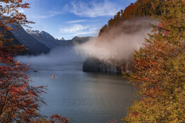 Morning fog in autumn over the Königssee in Berchtesgadener Land, Bavaria, Germany. Fog over the Königssee in Berchtesgadener Land, Bavaria, Germany, Europe