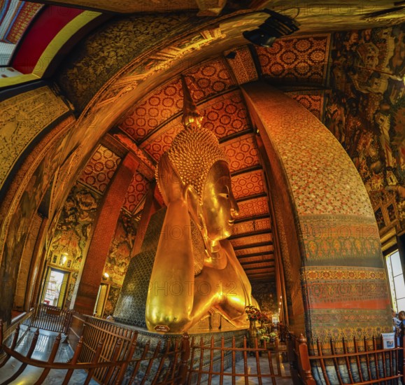 Photo of large lying golden Buddha statue in temple Wat Pho in capital city in Bangkok, Thailand, Asia