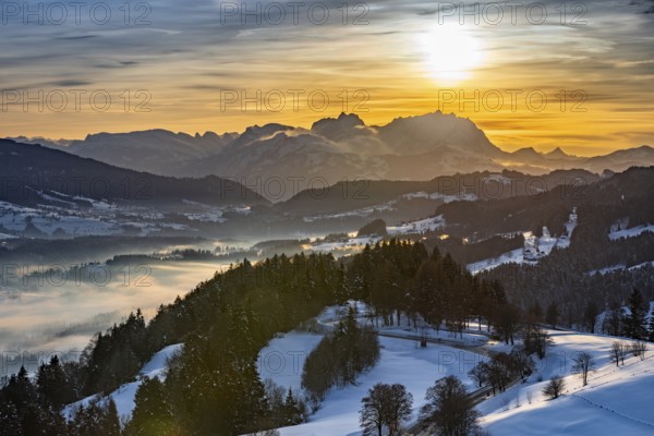 Dreamlike winter landscape at sunset with a view from the Allgäu Alps over the Bregenzerwald in Austria to the Säntis in Switzerland