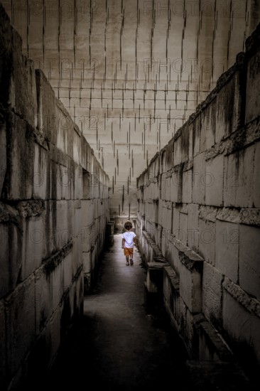 Caucasian young kid walking with labyrinth perspective. Conceptual image for dangerous situation during childhood