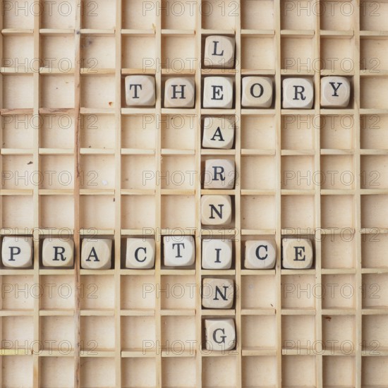 Learning concept with wooden dices and the words theory and practice