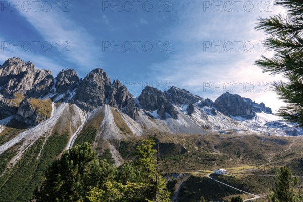 View at the Senders valley and Adolf Pichler mountain hut near Kemater Alm in Austria with high rising mountains (Kalkkoegel) in the background