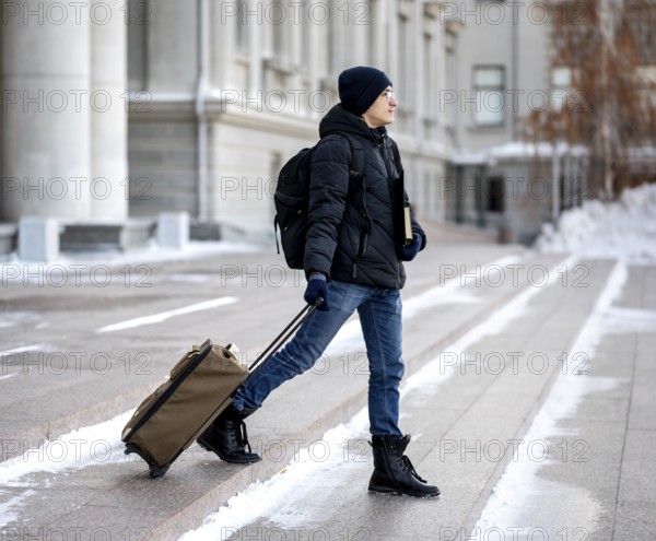 Portrait male student with books luggage