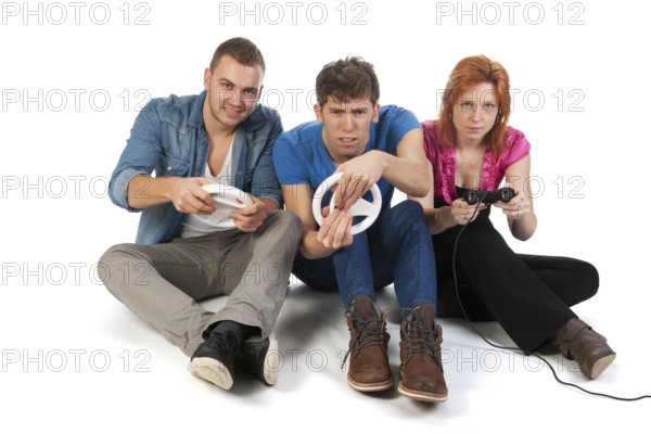 Three young friends ar gaming with the computer