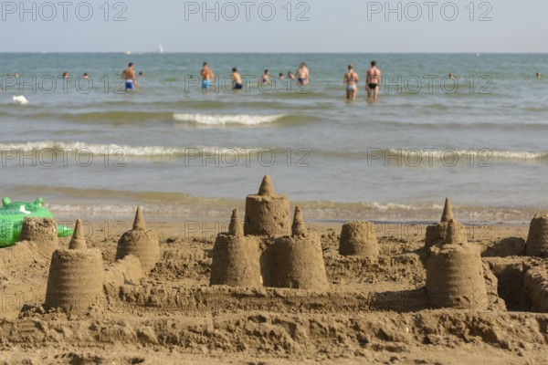 Several sandcastles on the beach off the coast - beach holiday