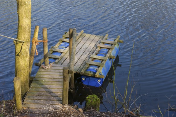 Handmade raft from shelves and plastic containers in the water