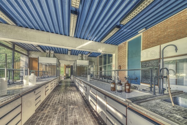 An abandoned laboratory room with long benches and glass containers under daylight, Institute of Molecular Biology, Lost Place, Sint-Genesius-Rode, Province of Flemish Brabant, Belgium, Europe