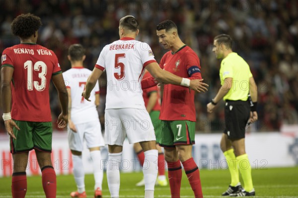 Football match, captain Cristiano RONALDO CR7 Portugal r. with captain's armband is watched from behind by Jan BEDNAREK Poland 5 during a free kick, Cristiano RONALDO Portugal r. tries to break away from his opponent, Estadio do Dragao, Porto, Portugal, Europe