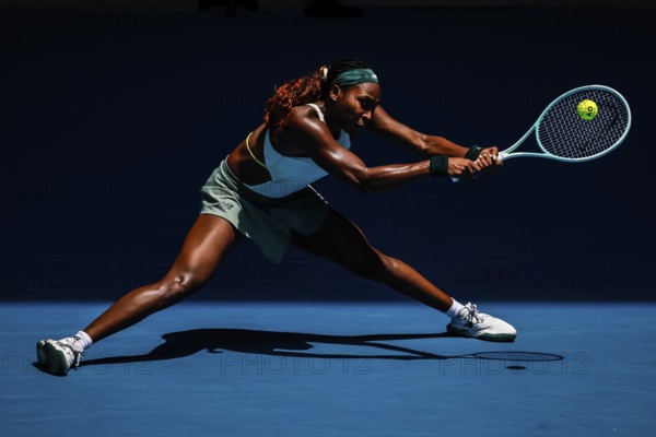 MELBOURNE, AUSTRALIA - JANUARY 19: Coco Gauff of USA hits a backhand to Belinda Bencic of Switzerland on day eight of the 2025 Australian Open at Melbourne Park on January 19, 2025 in Melbourne, Australia, Oceania