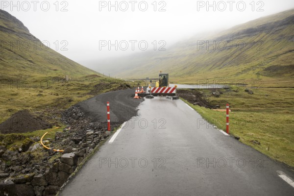Road construction site on the Faroe Islands with road block sign and digger, Streymoy, Faroe Islands, Denmark, Europe