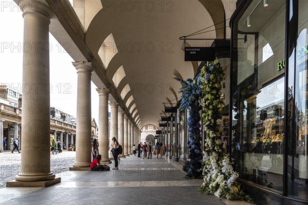 London, UK, May 15, 2019: View of the colonnade of Royal Opera House in Covent Garden area. Covent Garden is renowned for its luxury fashion and beauty stores, restaurants and theatres