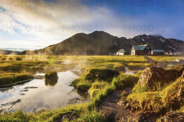 Sunrise Park Landmannalaugar. Above the source of thermal water steam rises. White nights in Iceland
