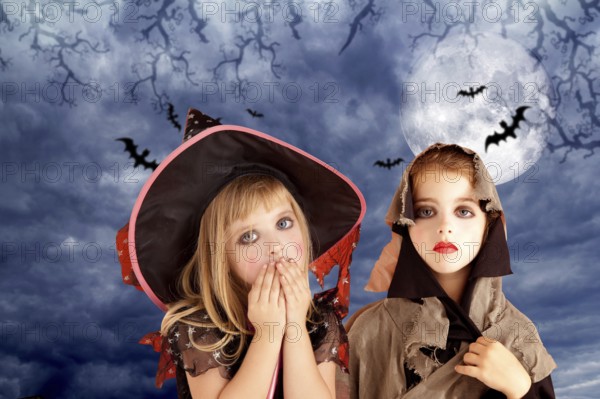 Halloween costumes kid girls on moon night sky with bats