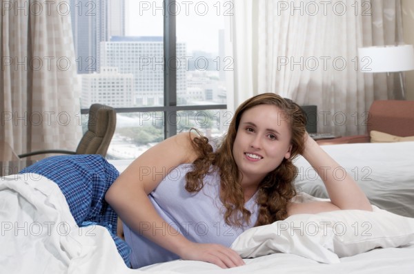 Beautiful young woman in bed at bedtime
