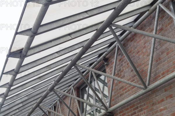 Large metal canopy with supports from below