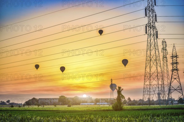 Electric station and air balloons in Luxor at sunrise