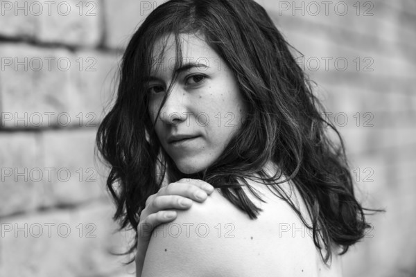 Portrait of a 27 year old white woman showing her naked schoulde, Brussels, Belgium, Europe