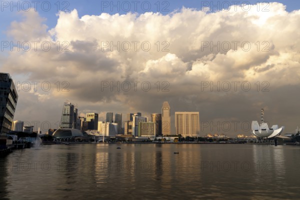 Skyline at sunset with thundercloud, Marina Bay, Singapore, Singapore, Asia