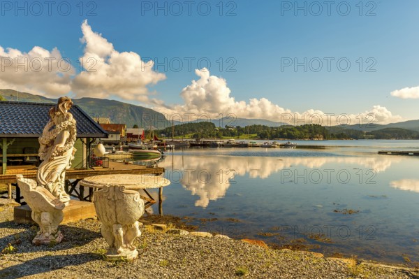 Stone figure, harbour, fishing village Norway, Valsøyfjorden, public ground